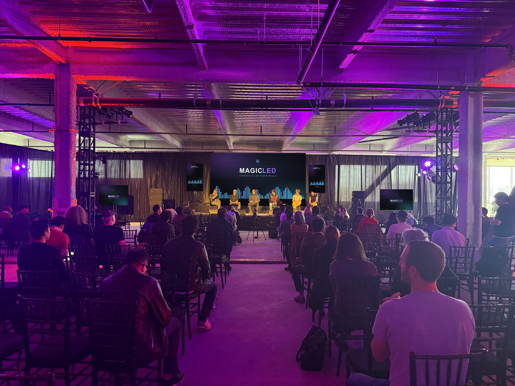 Warehouse event space from the back corner, Magic LED wall on stage