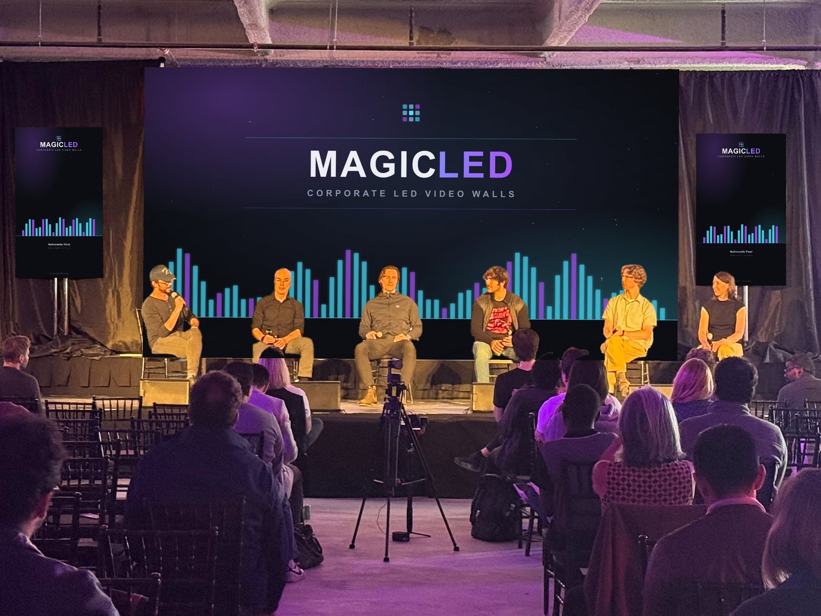 Magic LED video wall behind a six-person panel, audience seated in front